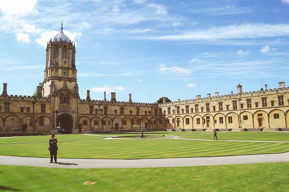 Historic stone college buildings around a lawn